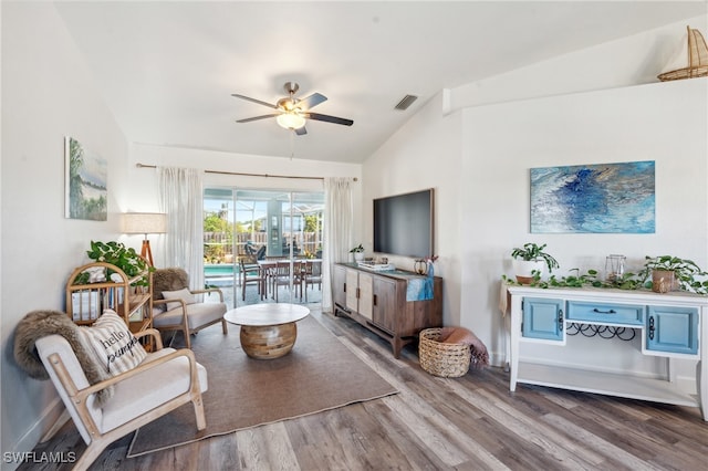 living room featuring ceiling fan, lofted ceiling, and wood-type flooring