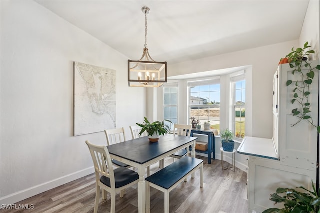 dining room featuring hardwood / wood-style flooring and a notable chandelier