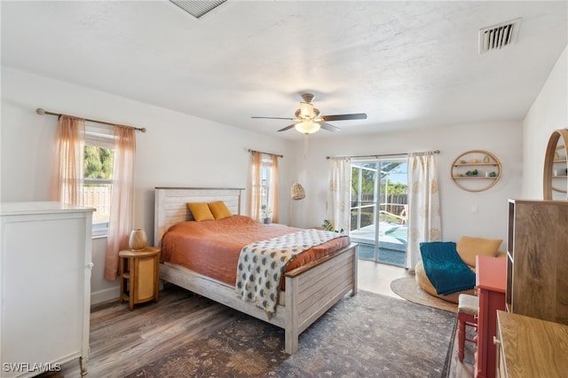 bedroom with dark hardwood / wood-style flooring, access to exterior, and ceiling fan