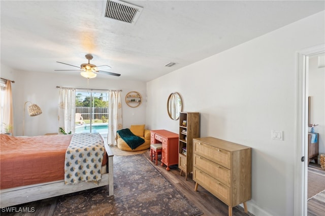 bedroom featuring dark wood-type flooring, access to exterior, and ceiling fan