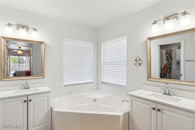 bathroom with vanity, a washtub, and ceiling fan