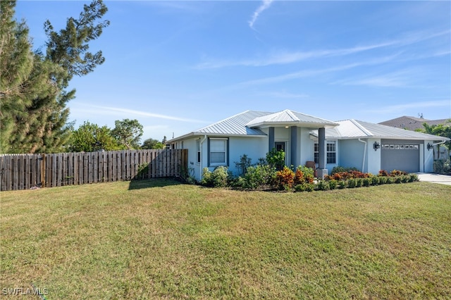 ranch-style home with a garage and a front yard