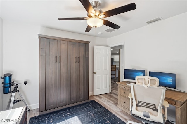 office area featuring dark hardwood / wood-style floors and ceiling fan