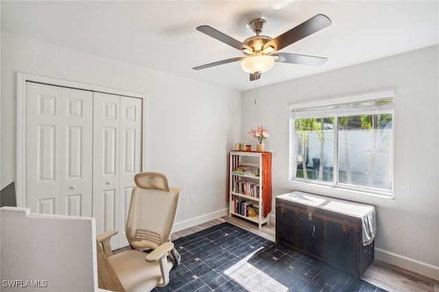 sitting room featuring ceiling fan