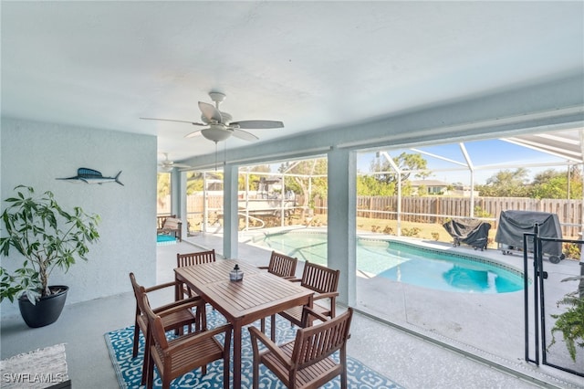 view of pool featuring a lanai, area for grilling, ceiling fan, and a patio area