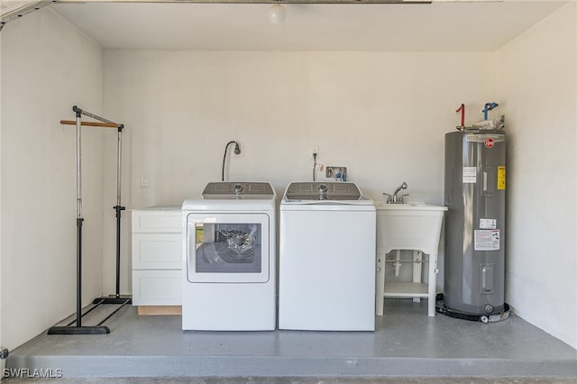 clothes washing area featuring washing machine and dryer and water heater