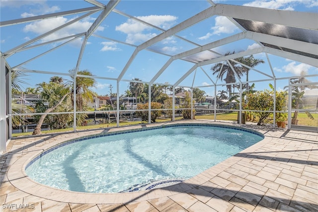 view of pool featuring a patio and glass enclosure