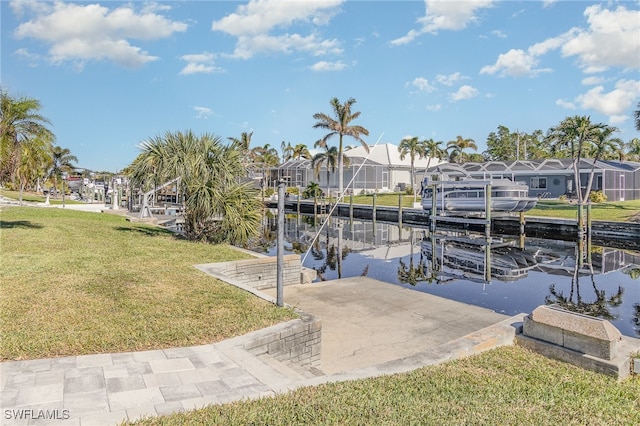 dock area with a yard and a water view