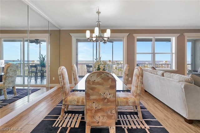 dining space featuring crown molding and light wood-type flooring