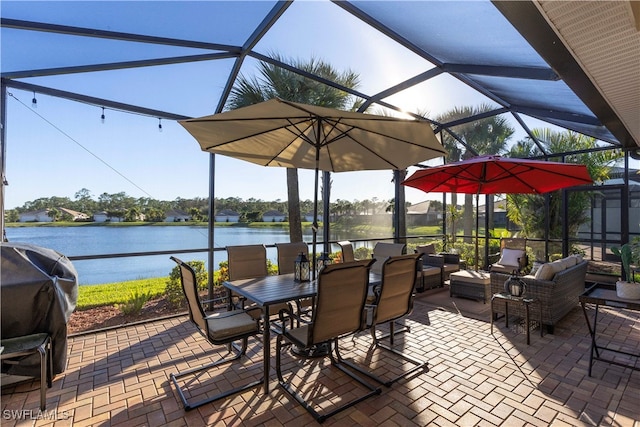 view of patio featuring a lanai, grilling area, an outdoor living space, and a water view