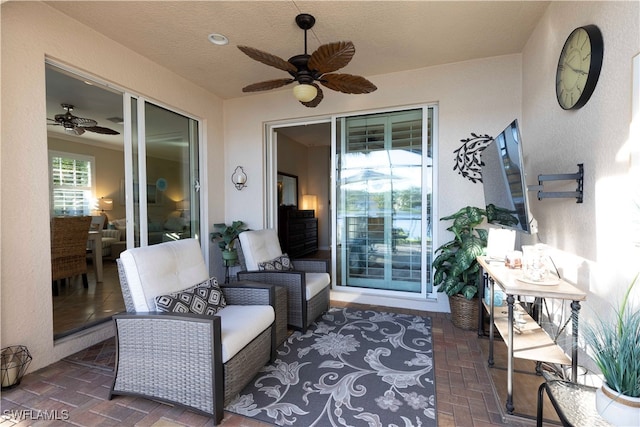 view of patio with an outdoor living space and ceiling fan