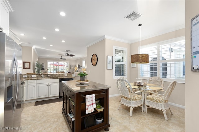 kitchen featuring white cabinetry, ceiling fan, stainless steel appliances, dark brown cabinets, and ornamental molding