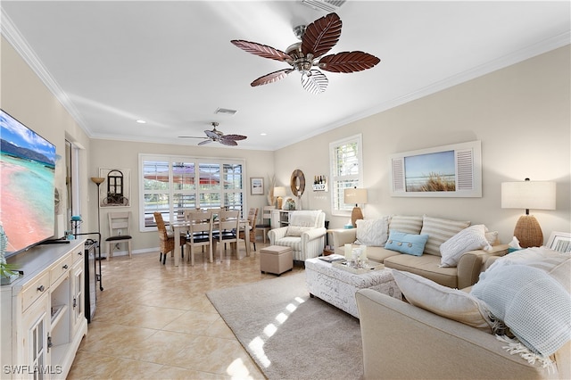 living room featuring light tile patterned floors, plenty of natural light, ornamental molding, and ceiling fan