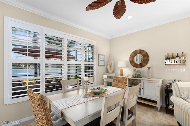 dining space featuring plenty of natural light, light tile patterned flooring, and ornamental molding