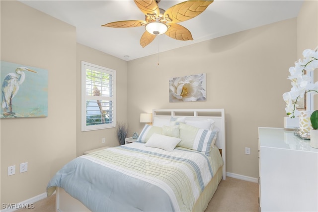 bedroom featuring ceiling fan and light carpet