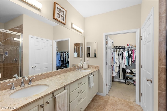 bathroom with vanity, tile patterned floors, and a shower with shower door