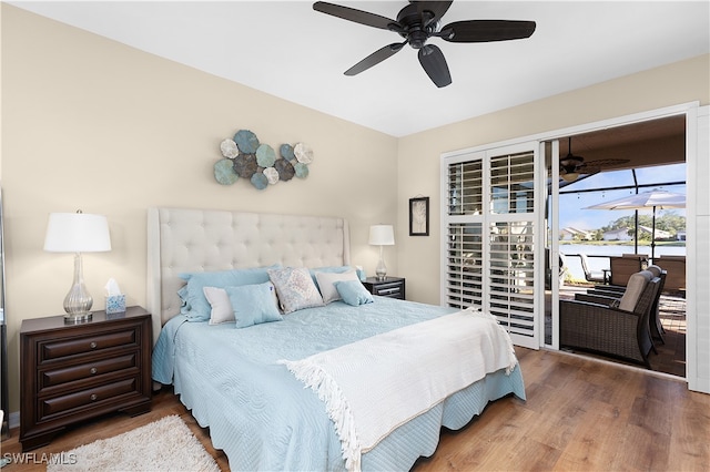 bedroom featuring hardwood / wood-style flooring, ceiling fan, and access to outside