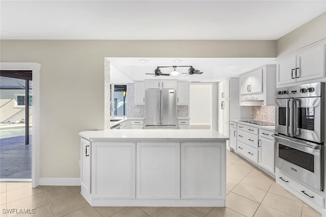 kitchen featuring stainless steel appliances, white cabinetry, and a wealth of natural light