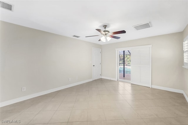 tiled empty room featuring ceiling fan