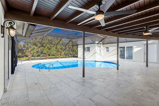 view of swimming pool featuring a lanai, a patio area, and ceiling fan