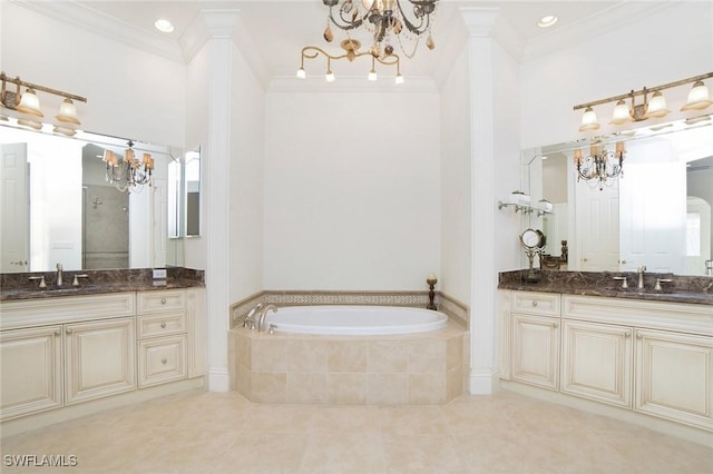 bathroom featuring tiled bath, vanity, tile patterned floors, and crown molding