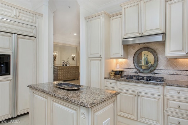 kitchen with stainless steel gas cooktop, decorative backsplash, and stone countertops