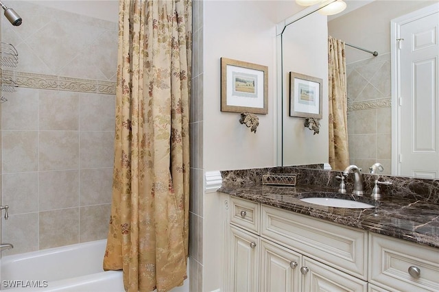 bathroom featuring shower / bath combo and vanity