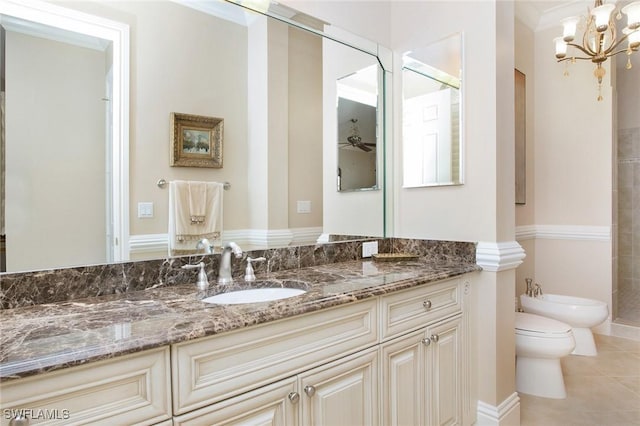 bathroom with toilet, vanity, crown molding, a bidet, and ceiling fan with notable chandelier