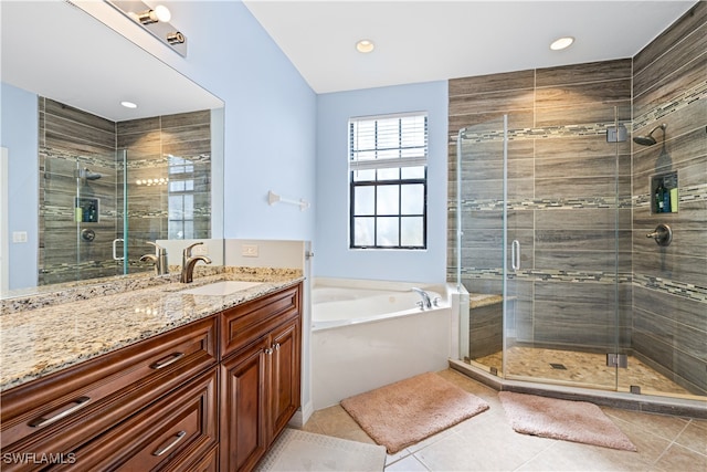 bathroom featuring vanity, tile patterned flooring, and plus walk in shower