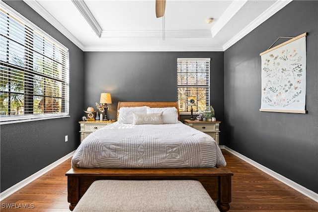 bedroom with ceiling fan, dark hardwood / wood-style flooring, and ornamental molding