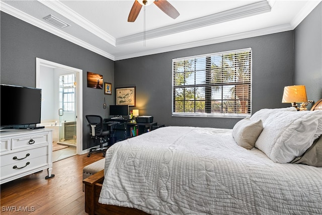 bedroom with ceiling fan, wood-type flooring, connected bathroom, and multiple windows