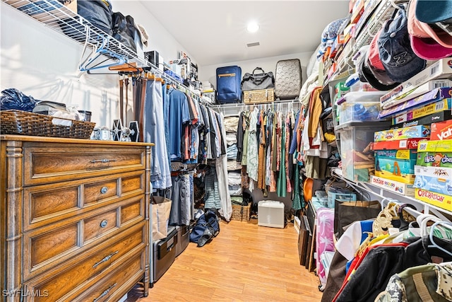 spacious closet with light hardwood / wood-style flooring