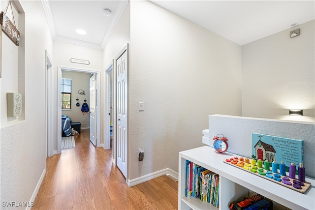 hall featuring ornamental molding and light wood-type flooring