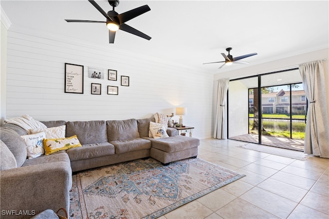 living room featuring crown molding, light tile patterned floors, and ceiling fan