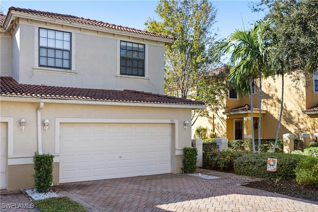 mediterranean / spanish-style home with a garage