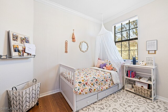 bedroom featuring hardwood / wood-style floors and crown molding