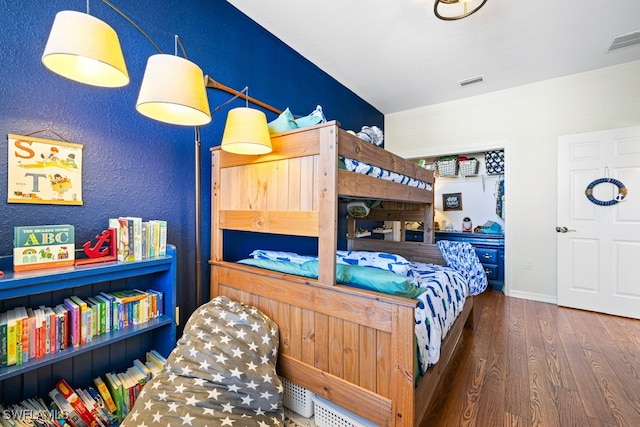 bedroom with dark wood-type flooring