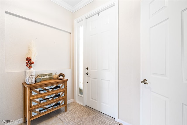 entryway featuring crown molding and light tile patterned floors