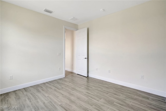 spare room with light hardwood / wood-style floors