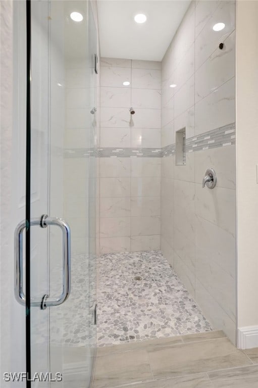 bathroom featuring a shower with shower door