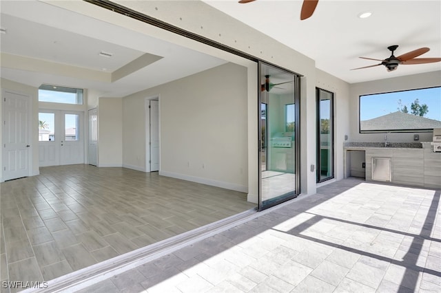 view of patio / terrace with ceiling fan and exterior kitchen