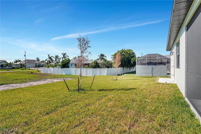 view of yard featuring glass enclosure