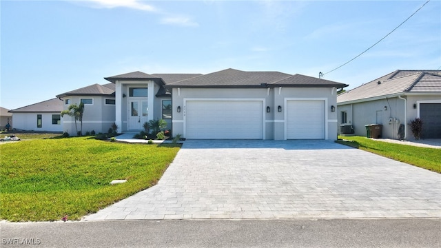 view of front facade with a garage and a front lawn