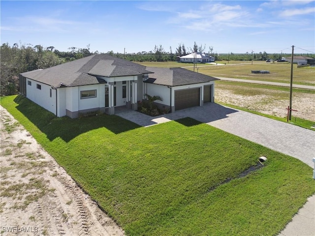 view of front of house with a garage and a front lawn