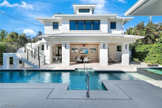 rear view of property with a patio area, ceiling fan, and an outdoor bar