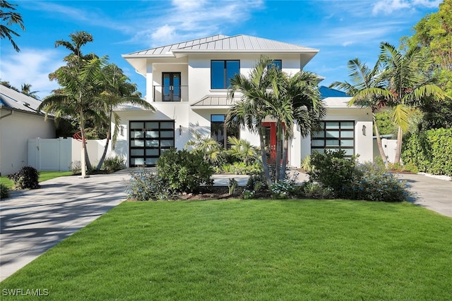 view of front facade featuring a front yard and a balcony