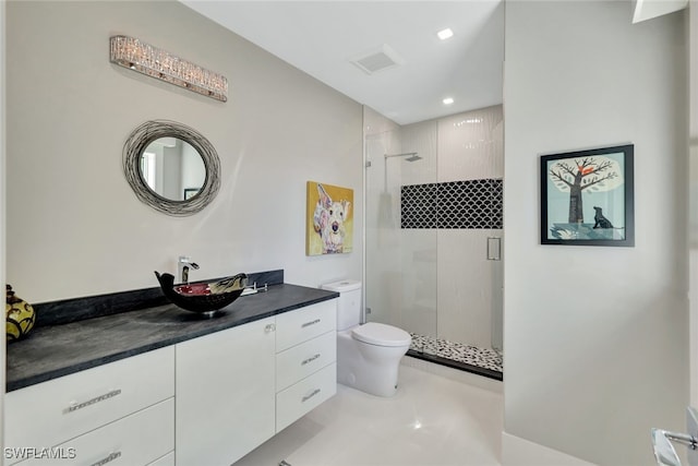 bathroom featuring vanity, toilet, and an enclosed shower