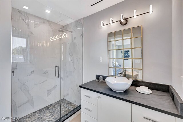 bathroom with vanity and a shower with shower door