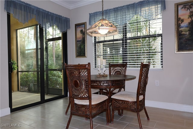 dining room featuring tile patterned flooring and crown molding