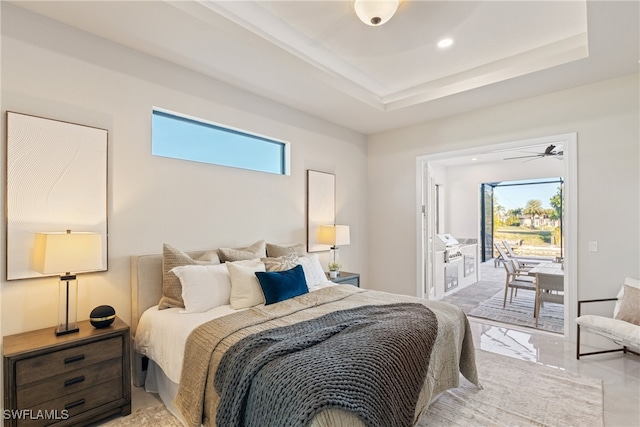 bedroom with a tray ceiling and access to outside